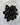 Black obsidian tumbled stone in polished volcanic glass with reflective surface